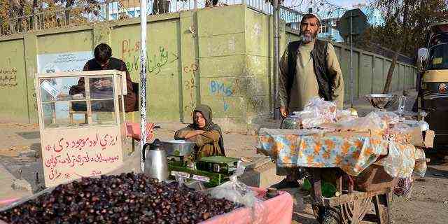 Ein Verkäufer verkauft am 29. November 2021 Datteln entlang einer Straße in Kandahar. (Foto von JAVED TANVEER/AFP über Getty Images)