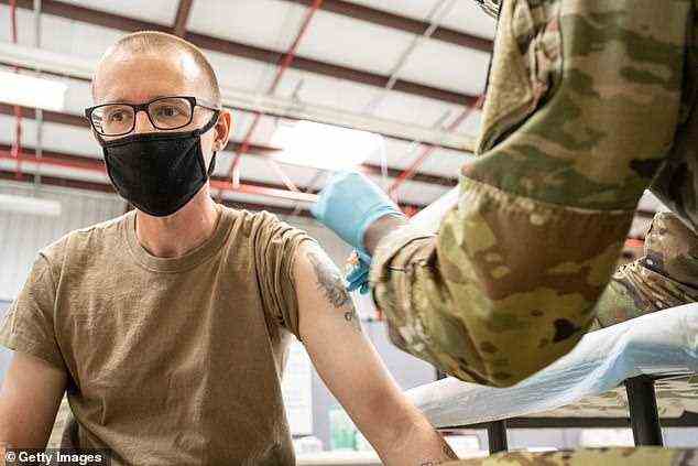 The AstraZeneca vaccine may give longer-lasting immunity that is now helping to shield the United Kingdom from Europe's latest deadly wave of Covid-19. Pictured: A soldier is administered COVID-19 vaccine on September 9, 2021 in Fort Knox, Kentucky (file photo)