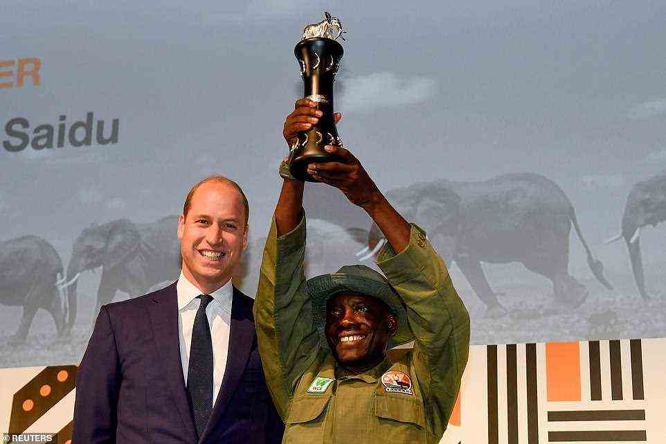 Tusk Wildlife Ranger Award winner Suleiman Saidu holds his trophy next to Prince William at the Tusk Conservation Awards in London