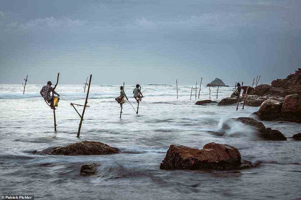 Pictured here are stilt fishermen in Sri Lanka at work in a bay between Koggala and Weligama in the southern part of the island. The men are practicing a traditional fishing technique known as Ritipanna, which originated after World War II. It involves mounting wooden stakes that have been driven into the reef and using fishing rods to catch mackerel, sardines and herring. The book reads: 'Evenings is their time because the tides determine success. The fish bite the best just before the sun sets.' Sadly, the tradition is in danger, according to the book, as in modern times 'those who dream of a big catch have to take a boat far out to sea'