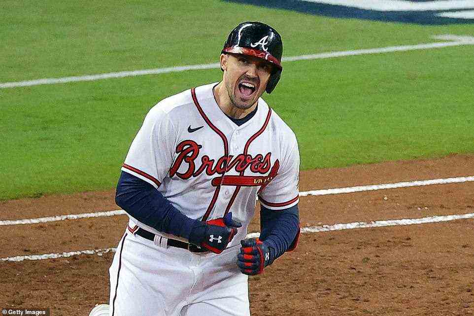 Adam Duvall #14 of the Atlanta Braves celebrates as he rounds the bases after hitting a grand slam home run against the Houston Astros during the first inning in Game Five of the World Series at Truist Park on Sunday