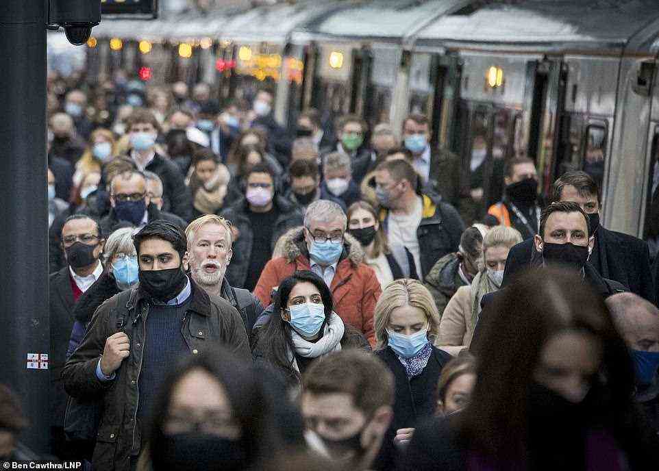 Hundreds of commuters, some not wearing masks, disembarked trains at London's Kings Cross Station today