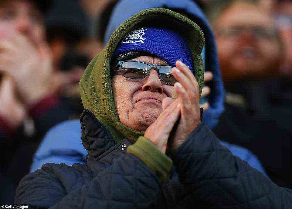 A tearful Birmingham City FC fan claps as the club and its supporters marked the life of youngster Arthur Labinjo-Hughes
