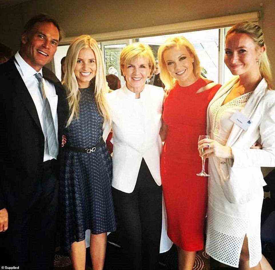 The relationship has left many shocked as both couples had been friends for years (pictured, Ellie Aitken, in red, alongside former Liberal Party deputy leader Julie Bishop, centre, with Hollie Nasser, in blue, at Ms Aitken's 40th birthday party in 2019)
