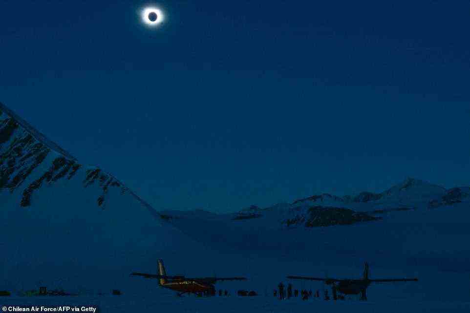 The rare spectacle of the moon blocking out the sun reached its greatest extent at around 07:33 GMT for spectators near the edge of Antarctica's Ronne Ice Shelf , which was plunged into darkness for two minutes. Pictured: darkness falls on the Union Glacier as the moon appears to block out the sun