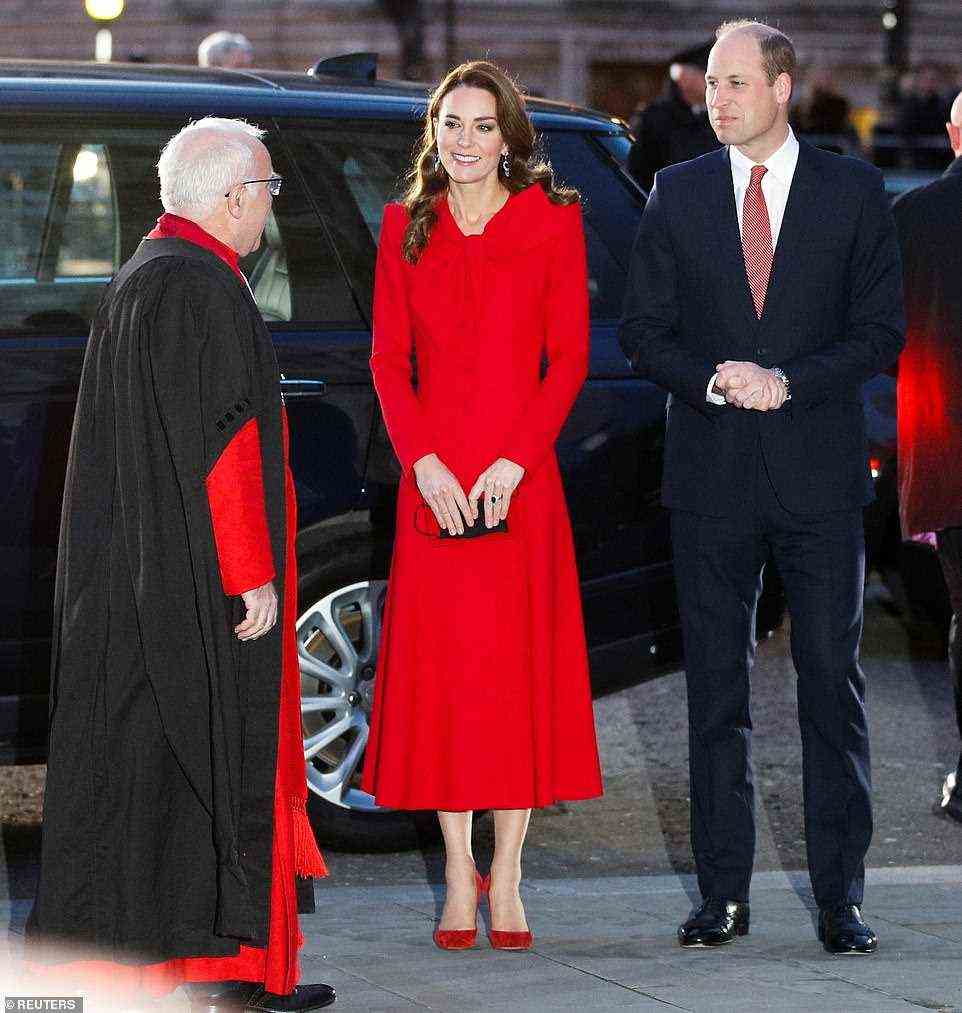 Meanwhile Prince William complemented his wife's festive ensemble by opting for a smart navy suit with a red tie for the outing today
