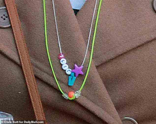 She also wore a pair of necklaces that appear to have been made by her children, Israel and Samuel. One, with letter beads, spells out her name