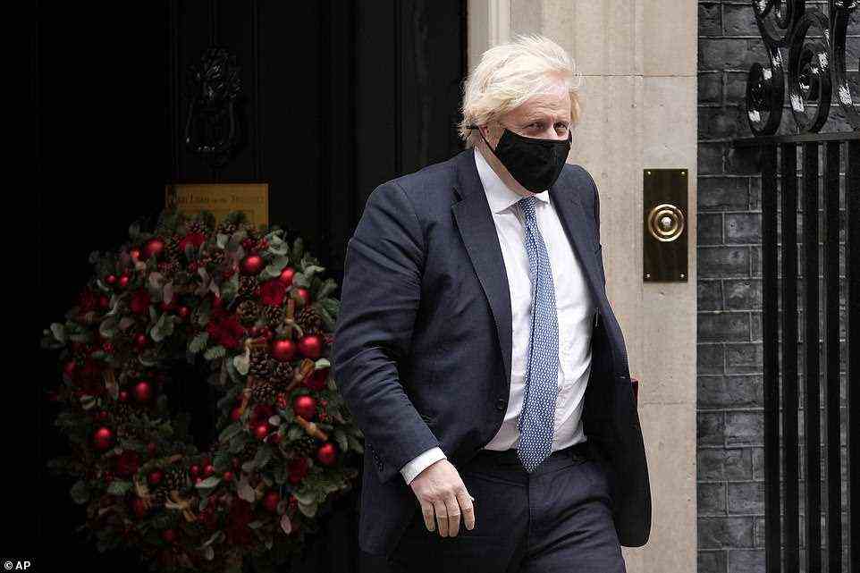 Boris Johnson (pictured leaving 10 Downing Street to attend Prime Minister's Questions in the Commons today) is on the verge of bowing to mounting alarm about the risk of the NHS being overwhelmed by bringing in tougher restrictions, likely to include a blanket order to work from home where possible, more mask-wearing and Covid passports