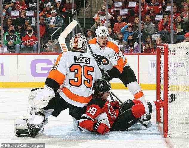 Soccer has now overtaken ice hockey in the US league table of popular sports. Pictured: Dawson Mercer #18 of the New Jersey Devils crashes into Martin Jones #35 and Nick Seeler #24 of the Philadelphia Flyers at the Prudential Center on November 28, 2021 in Newark