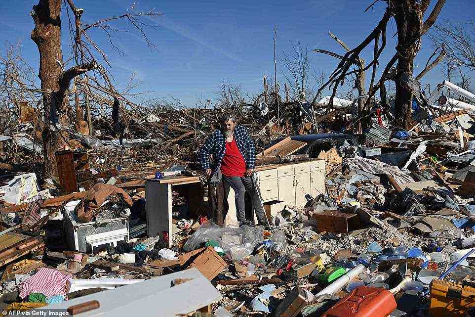 Bogdan Gaicki surveys tornado damage Sunday in Mayfield, Kentucky after extreme weather hit the region, leaving more than 80 people dead in the deadliest storm in Kentucky history