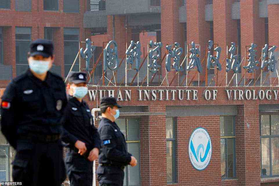Security personnel keep watch outside the Wuhan Institute of Virology during the visit by the WHO team tasked with investigating the origins of Covid, February 3, 2021