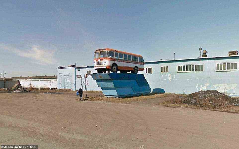 This image of a Soviet monument in the coal mining town of Vorkuta, just north of the Arctic Circle, was snapped as a woman carrying a shopping bag walked past. Cecil's foreword to the book explains: 'Around the static Soviet relics, scenes of everyday Russian life are captured by the all-seeing Google Street View'