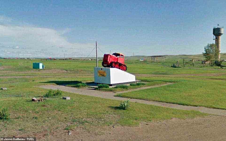 A red tractor crowns a plinth in Dornod, Mongolia, in this shot. The book explains: 'These lonely markers defined the ideology and territory of an enormous empire'