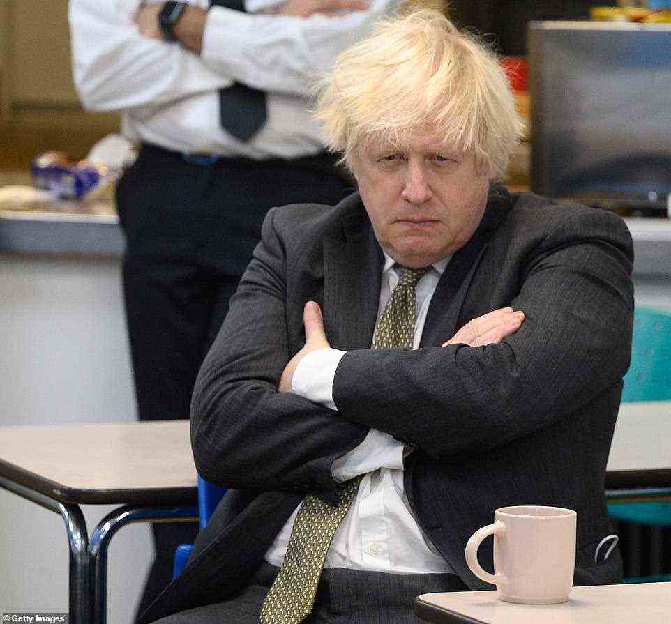 Prime Minster Boris Johnson — who has repeatedly refused to rule out another lockdown if Omicron is as bad as scientists say — sits with members of the Metropolitan Police in their break room, as he makes a constituency visit to Uxbridge police station on December 17