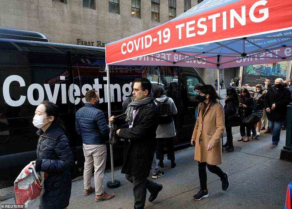 New York City has once again emerged as one of the nation's Covid hubs. Official numbers show that around 1% of sequenced cases in the city are of the Omicron variant. Testing sites across the city have been plagued by long lines and nearly 8% of positive tests are coming back positive. Pictured: People in New York City wait in line to receive a Covid test on December 14