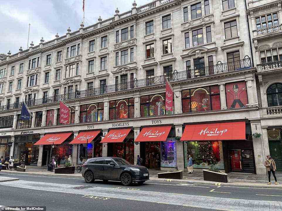Few people walk outside Hamleys toy shop on Regent Street in London's West End at 11.30am today as Britons stay at home