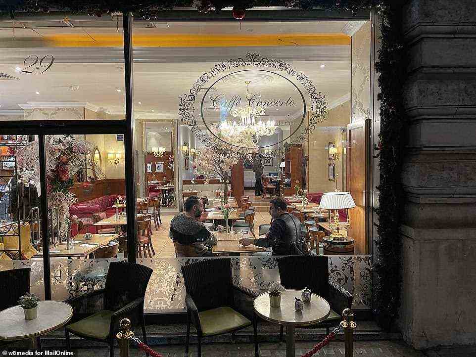Only two men can be seen sat a table inside this branch of Caffe Concerto on Piccadilly in London yesterday evening