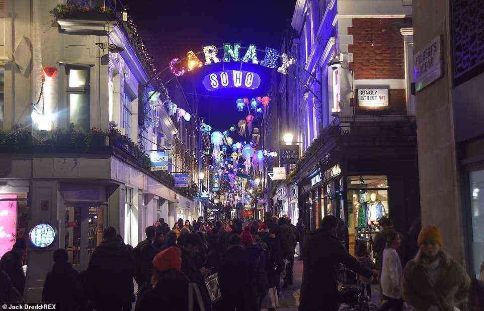 2019 -- Huge numbers of shoppers walk through Carnaby Street in London's West End on December 24, 2019