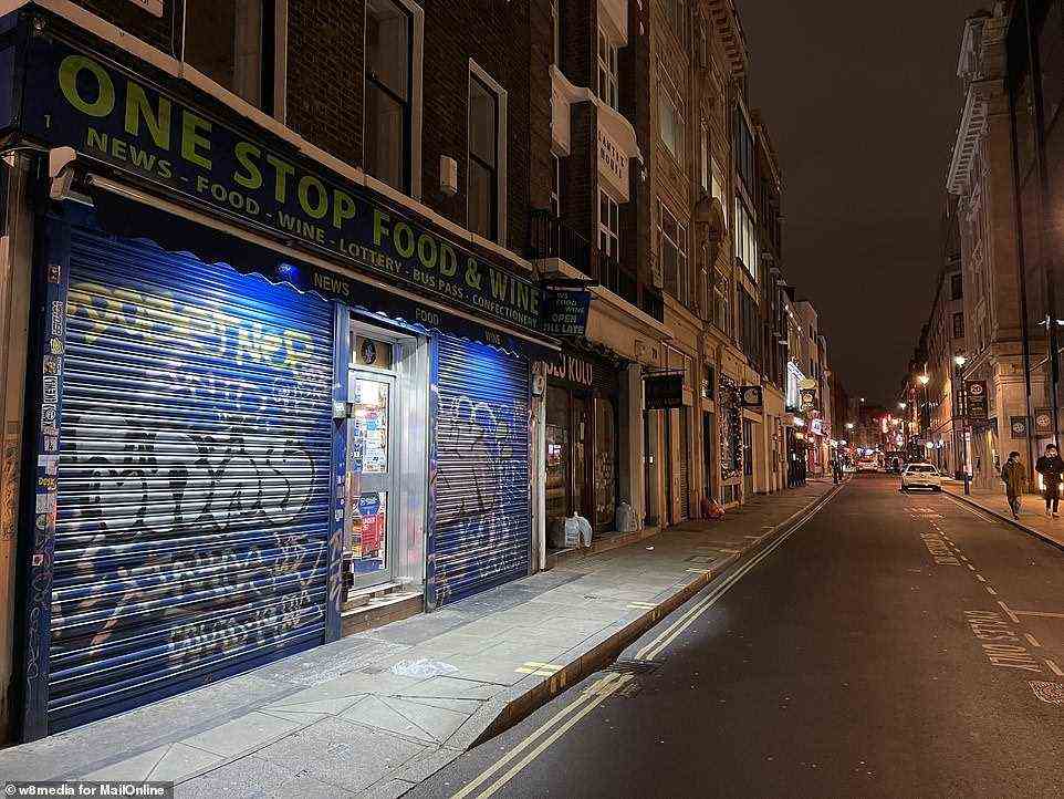 Boarded up shops and very few people around on Lower John Street in the West End of London yesterday evening