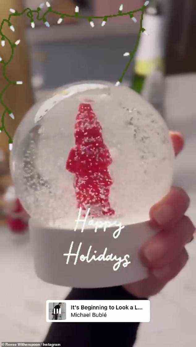 Snow! And then Witherspoon - who is a mother of three kids - gave fans a look at her snow globe as she wrote 'Happy Holiday's over the image