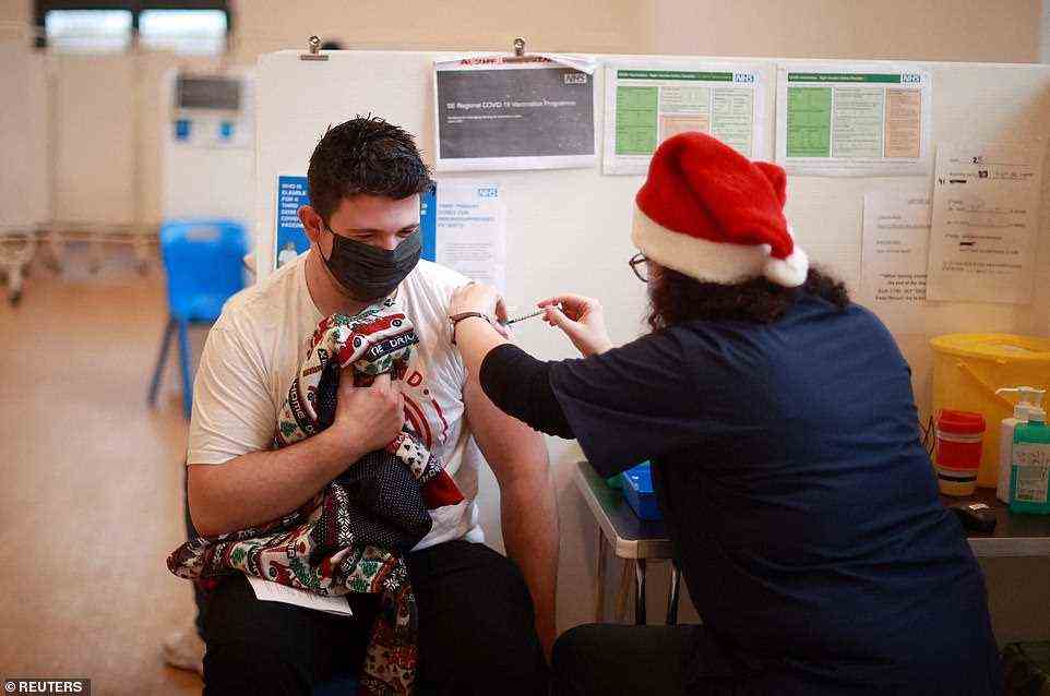 A man receives a Covid booster vaccine at the Sovereign Harbour Community Centre on Christmas Day in Eastbourne