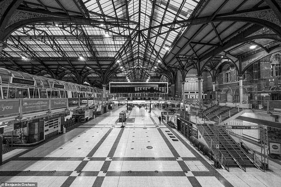 LIVERPOOL STREET -- A nearly-empty main concourse at London Liverpool Street station which was expanded, opened up and part-reconstructed in the 1980s, with decorative features such as the Great Eastern Railway Company war memorial (top right, above the Underground sign) repositioned. The station, which is located in the City of London, opened in 1874