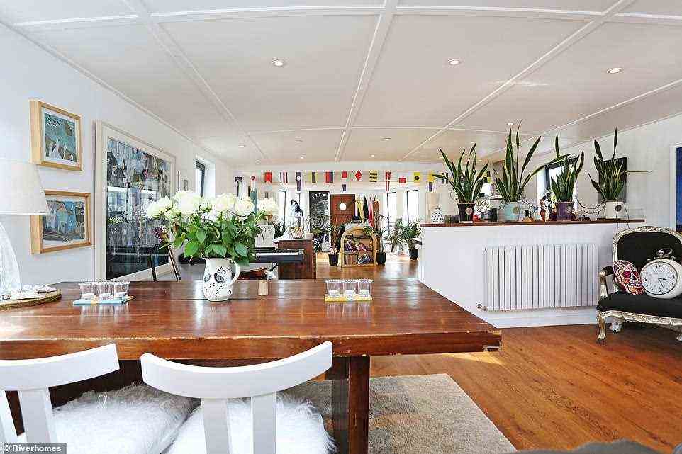 This meticulously renovated and fully operational barge comprises a large, open-plan living area which is flooded with natural light (pictured)