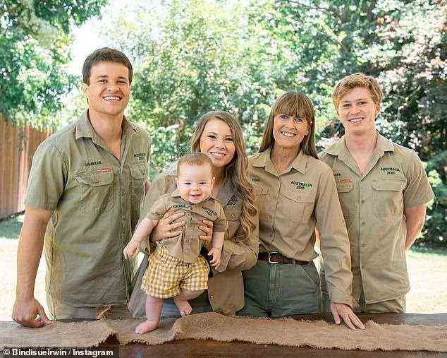 Moving on: After a challenging year of highs and lows, the Irwin family will no doubt be looking forward to saying goodbye to 2021 come New Year's Eve. Pictured from left: Chandler Powell, Bindi Irwin with daughter Grace, Terri Irwin and Robert Irwin