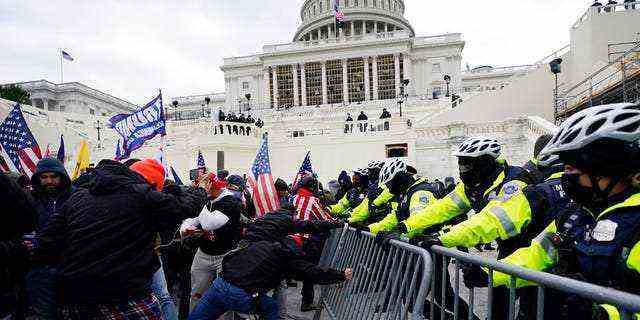 Trump-Anhänger versuchen am 6. Januar 2021 im Kapitol in Washington eine Polizeibarriere zu durchbrechen.