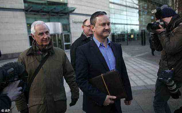 Gay rights activist Gareth Lee, center, leaves Laganside court, Northern Ireland, Thursday March 26, 2015