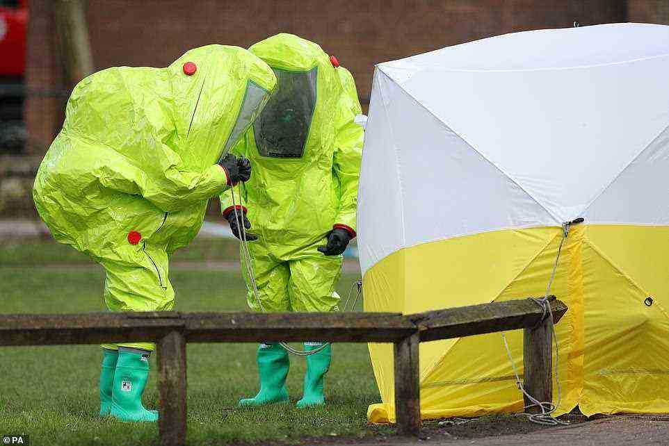 Personnel in hazmat suits working to secure a tent covering a bench in the Maltings shopping centre in Salisbury, where former Russian double agent Sergei Skripal and his daughter Yulia were found critically ill due to exposure to the nerve agent Novichok