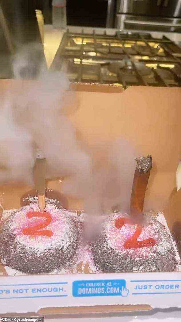 High times: She included a video of a two powdered sugar covered brown cakes in a Dominoes box that were decorated with red icing that read '22'. Two smoking marijuana joints were stuck inside of the cakes in place of candles