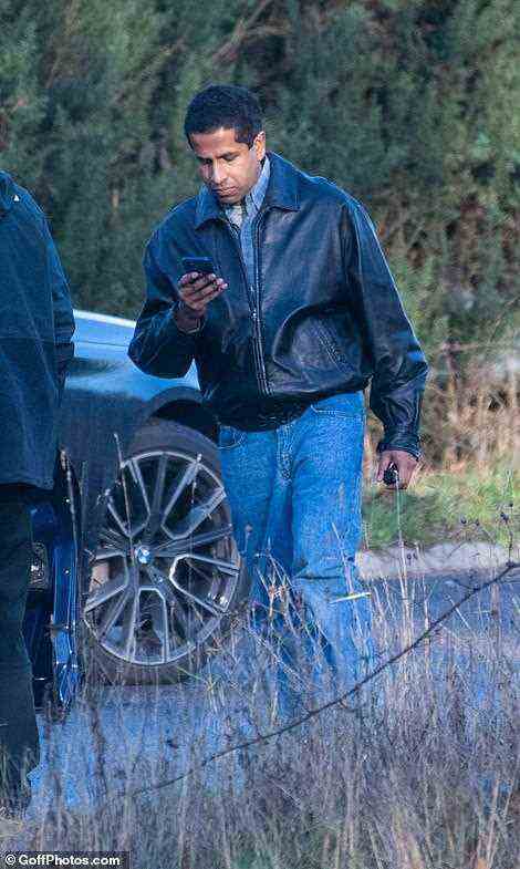 Meanwhile the actor could also be seen hopping out of the car and wandering around the set while looking at his mobile phone