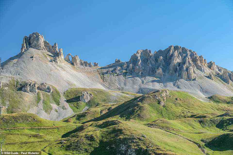 AIGUILLE PERCEE, HAUTE TARENTAISE: 'This magnificent rock arch atop a mountain ridge is a prominent skyline landmark,' write the authors, who add that there are 'immense' mountain views from the ridgeline. Coordinates: 45.4832, 6.8933