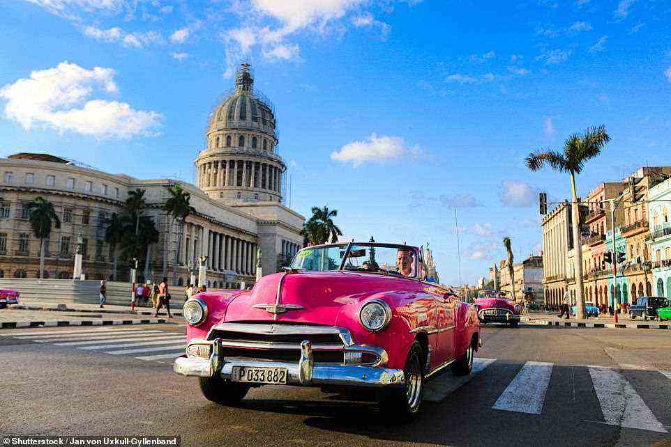 Riot of colour: Driving in Havana. On a road trip of the island, always drive during daylight hours to avoid potholes, horse-drawn carriages and pedestrians