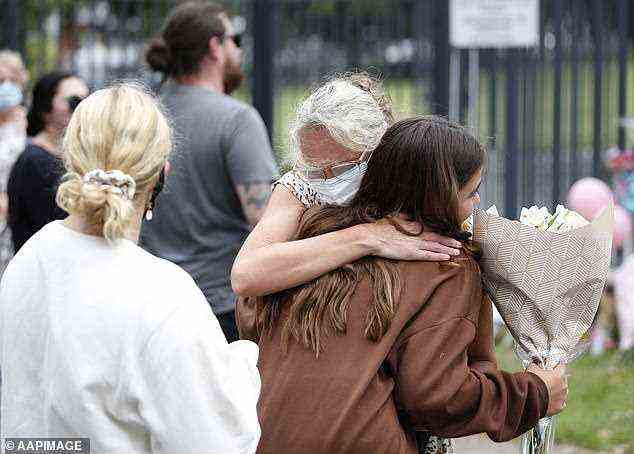 One mourner gave another a hug as crowds weathered the rain to say goodbye to Charlise