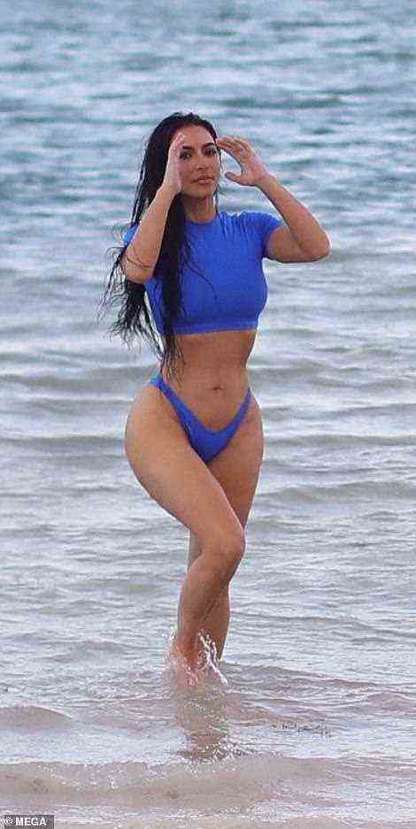 Kim posed for the photoshoot while emerging like a mermaid from the blue waters