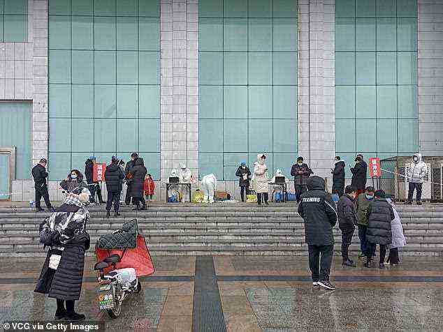 Around 1.2m people in Xiong'an are no longer allowed to enter or leave their residential compounds. Pictured: People receive Covid-19 nucleic acid test at a testing site in Anxin County on January 23