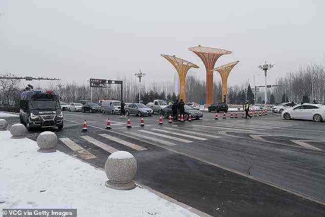 Policemen control traffic at Anxin County after new Covid-19 cases were reported on January 24 in Xiongan New Area