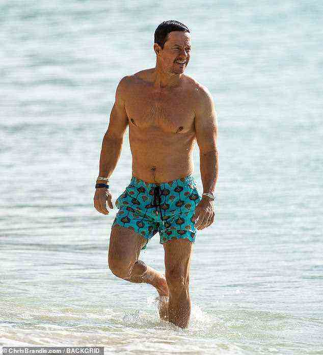 Buff: Mark Wahlberg zeigte seinen zerrissenen Körper, als er am Mittwoch zusammen mit seiner Frau, 43, in Barbados am Strand war