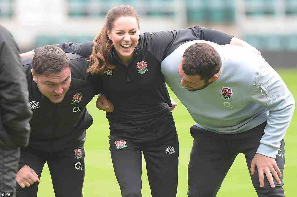 Showing her the ropes: England players Jamie George (left) and Ellis Genge (right) had Kate in fits of giggles on the pitch