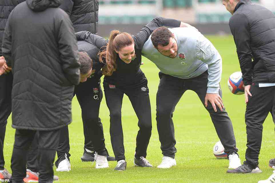 Ready for action: The Duchess of Cambridge was sandwiched between Jamie George (left) and Ellis Genge for the scrum