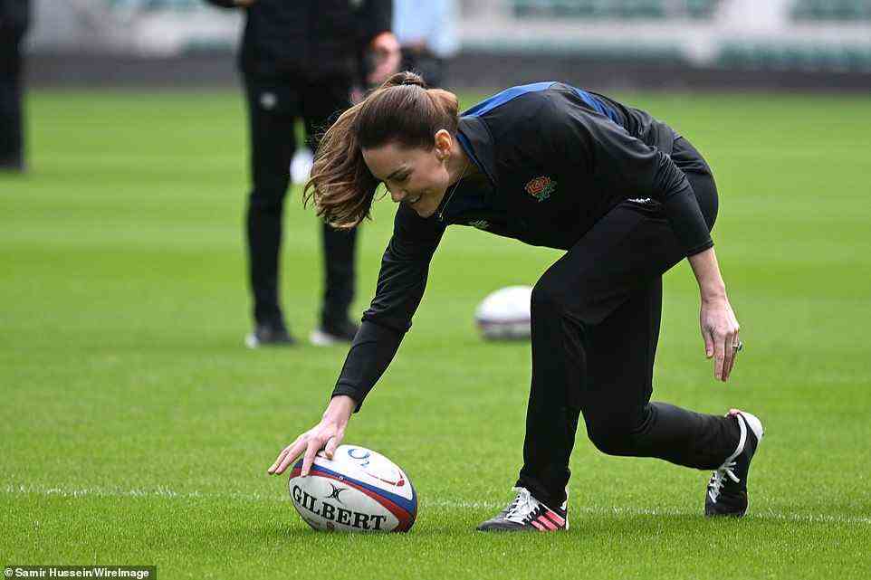 Putting her best foot forward: The Duchess of Cambridge lined up the ball for a kick as part of the training session today