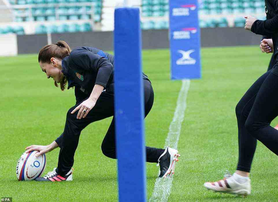 Giving chase: The England players jogged behind the Duchess of Cambridge as she crossed the try line and scored