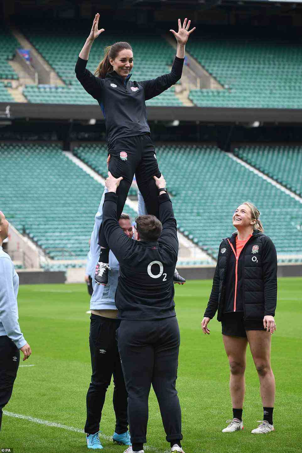 On top of the world! Kate was lifted up in a line-out during a visit to Twickenham Stadium where she met with England stars