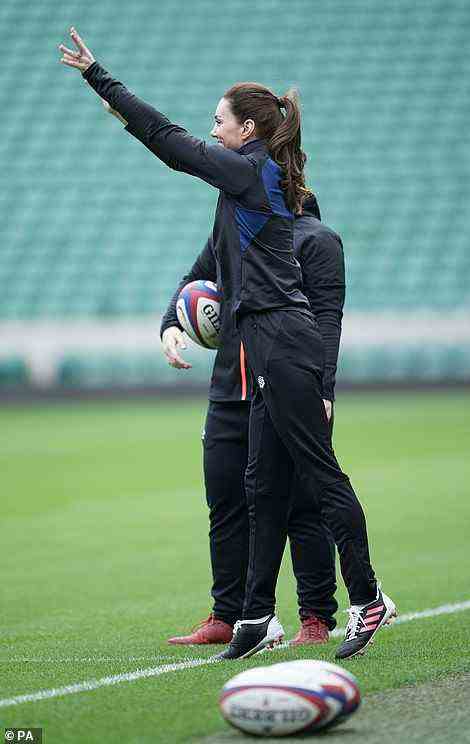 Kate throws a ball from the side of the pitch