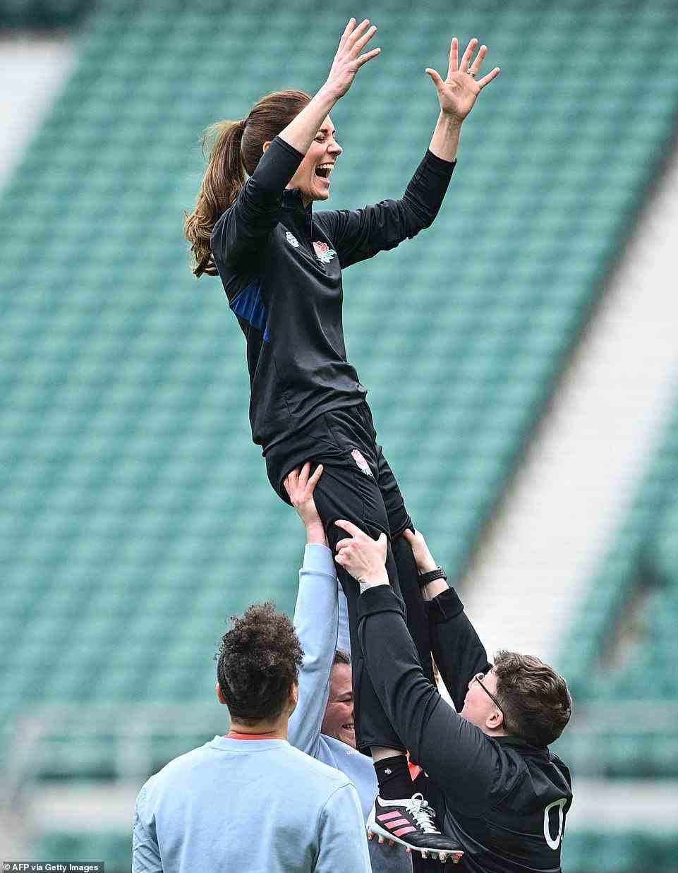 Pass it to the Princess! Kate looked delighted as she flew high in the air and met members of the men's and women's squads ahead of the Six Nations Championships and the Womens World Cup