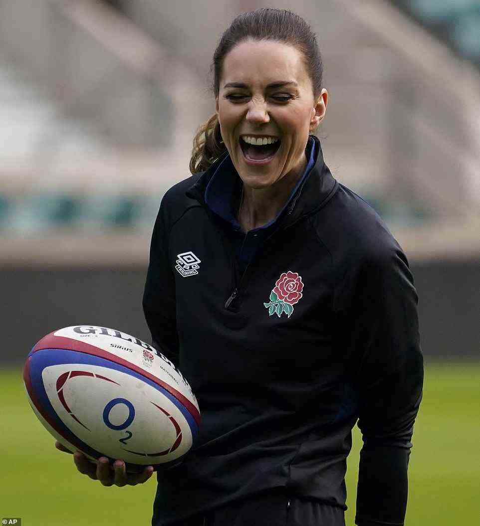 In her element! Sporty Kate donned the England Rugby kit and held onto a a O2 branded ball as she beamed in delight on the pitch