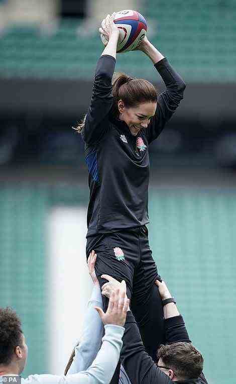 On top of the world! Kate was the perfect sporty princess as she lifted up in a line-out as she plays rugby during a visit to Twickenham Stadium,
