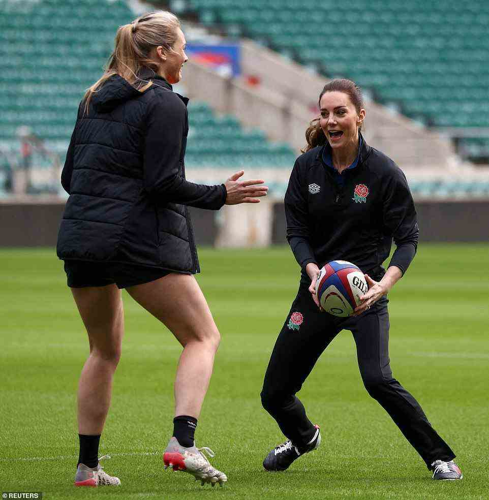 No tackling allowed! Kate looked ready to join the squad as she grabbed hold of the ball while England players attempted to tackle her